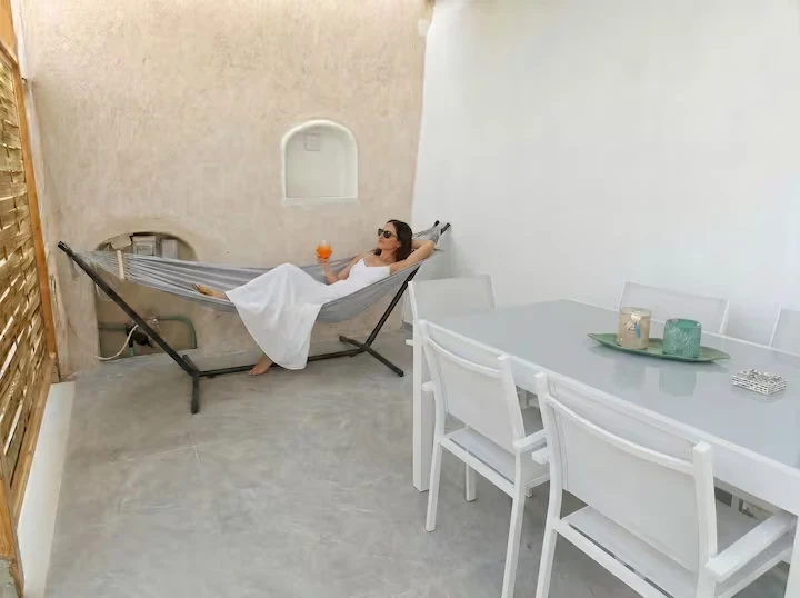 Private shaded patio with hammock and dining table