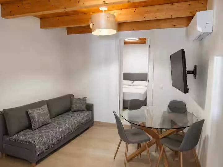 Minimal living room with sofa bed and dining space
