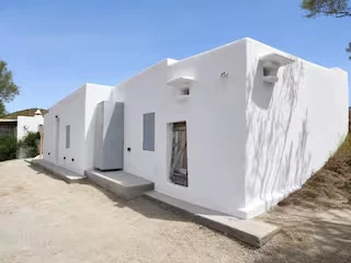 Whitewashed exterior of Perliti Cycladic House in Milos