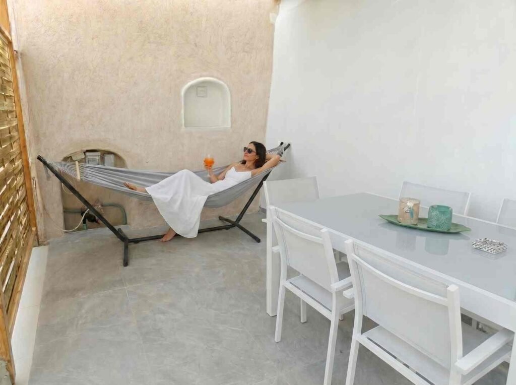 Guest relaxing in the hammock on the private shaded patio