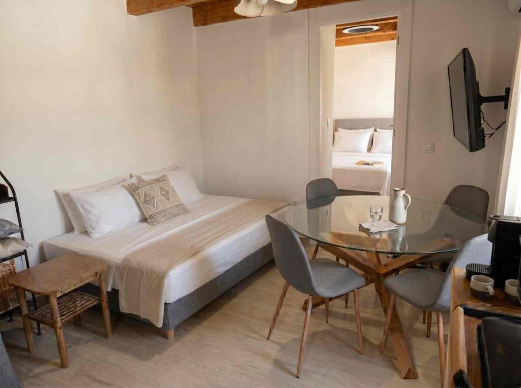 Living area with sofa bed, dining space, and adjoining bedroom